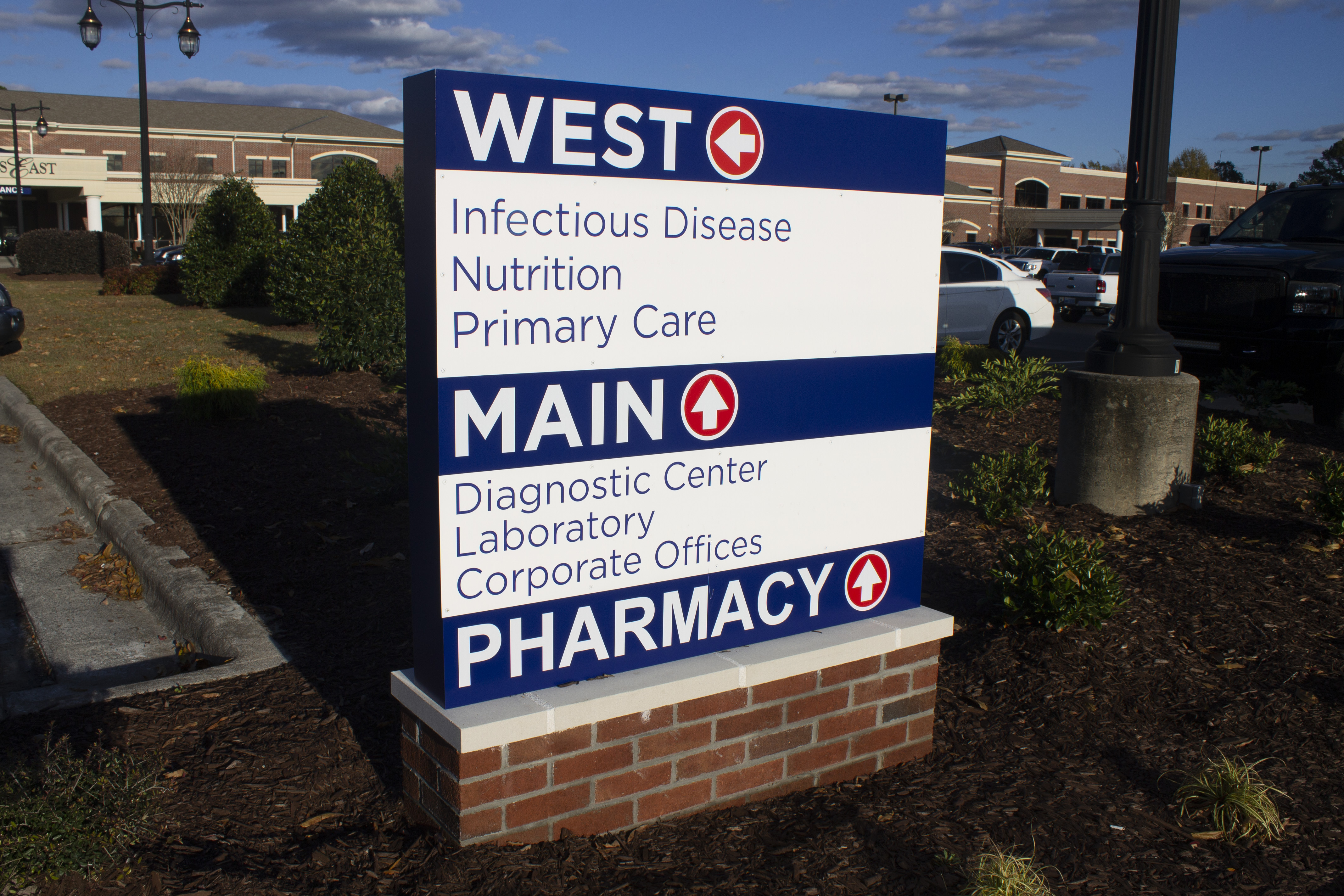 directional sign in a landscaped area 